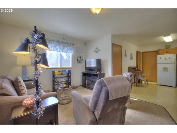 a kitchen with stainless steel appliances granite countertop a refrigerator a stove and a sink