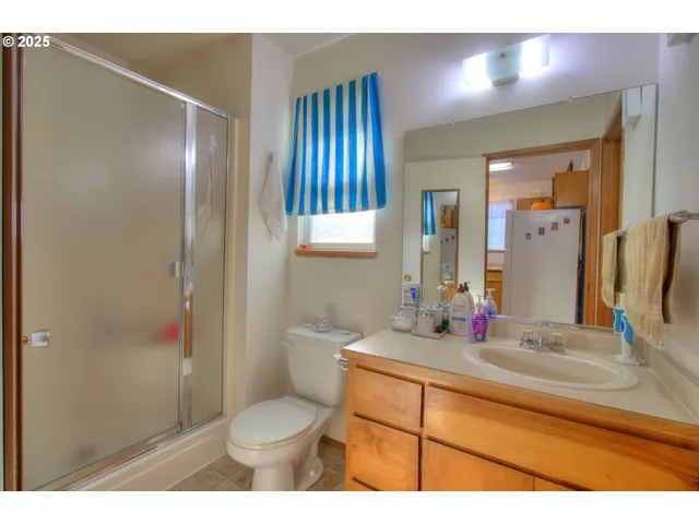 a bedroom with a bed and a flat tv screen on dresser
