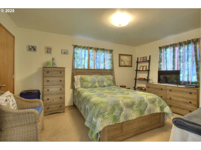 a bedroom with a bed next to a window