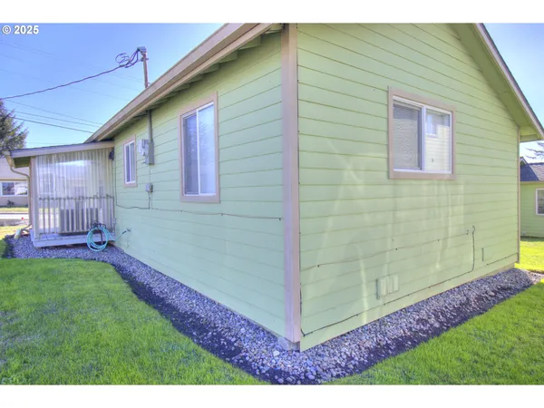 a backyard of a house with table and chairs