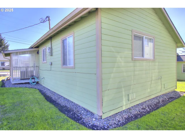 a backyard of a house with table and chairs