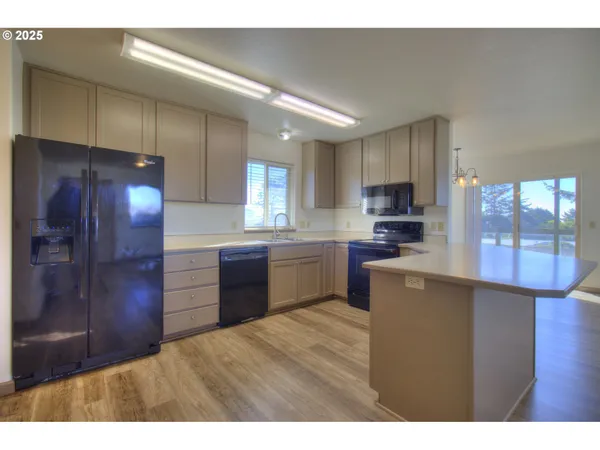 a kitchen with a refrigerator and a sink