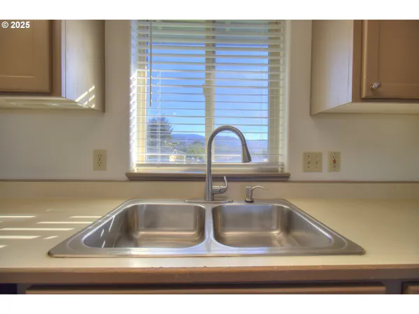 a kitchen with a wooden floor and window