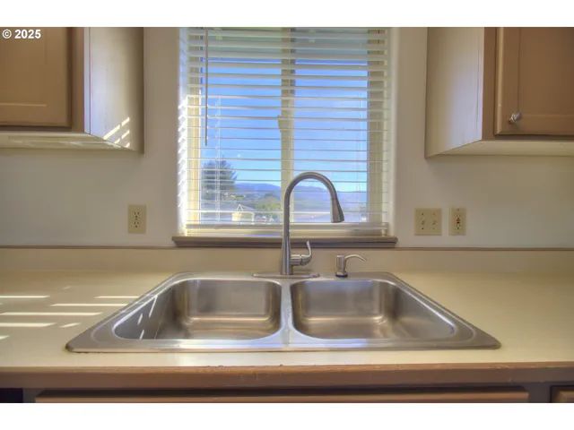 a kitchen with a wooden floor and window