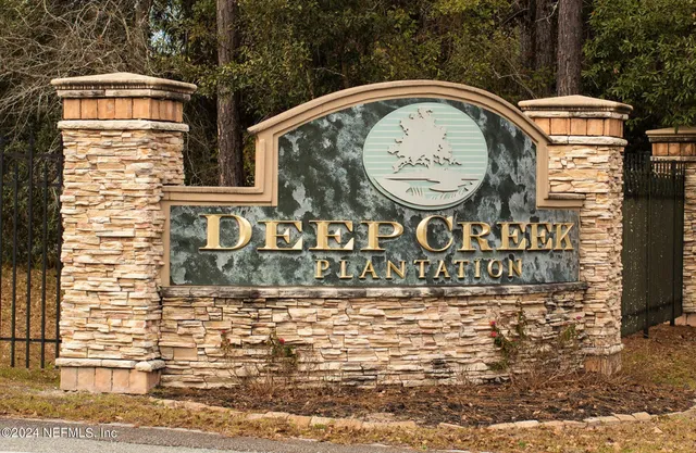 a view of a sign board with a car park side of the road