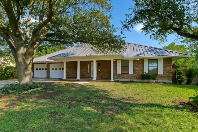 a front view of a house with a garden and porch