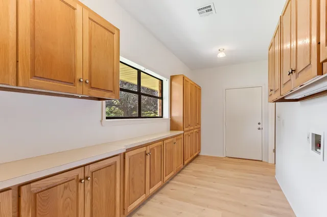 a view of an entryway with wooden floor