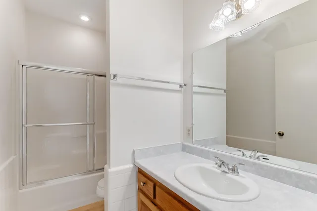 a bathroom with a sink vanity tub and shower