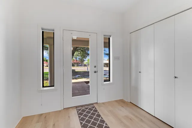 a view of an empty room with bathroom and a window