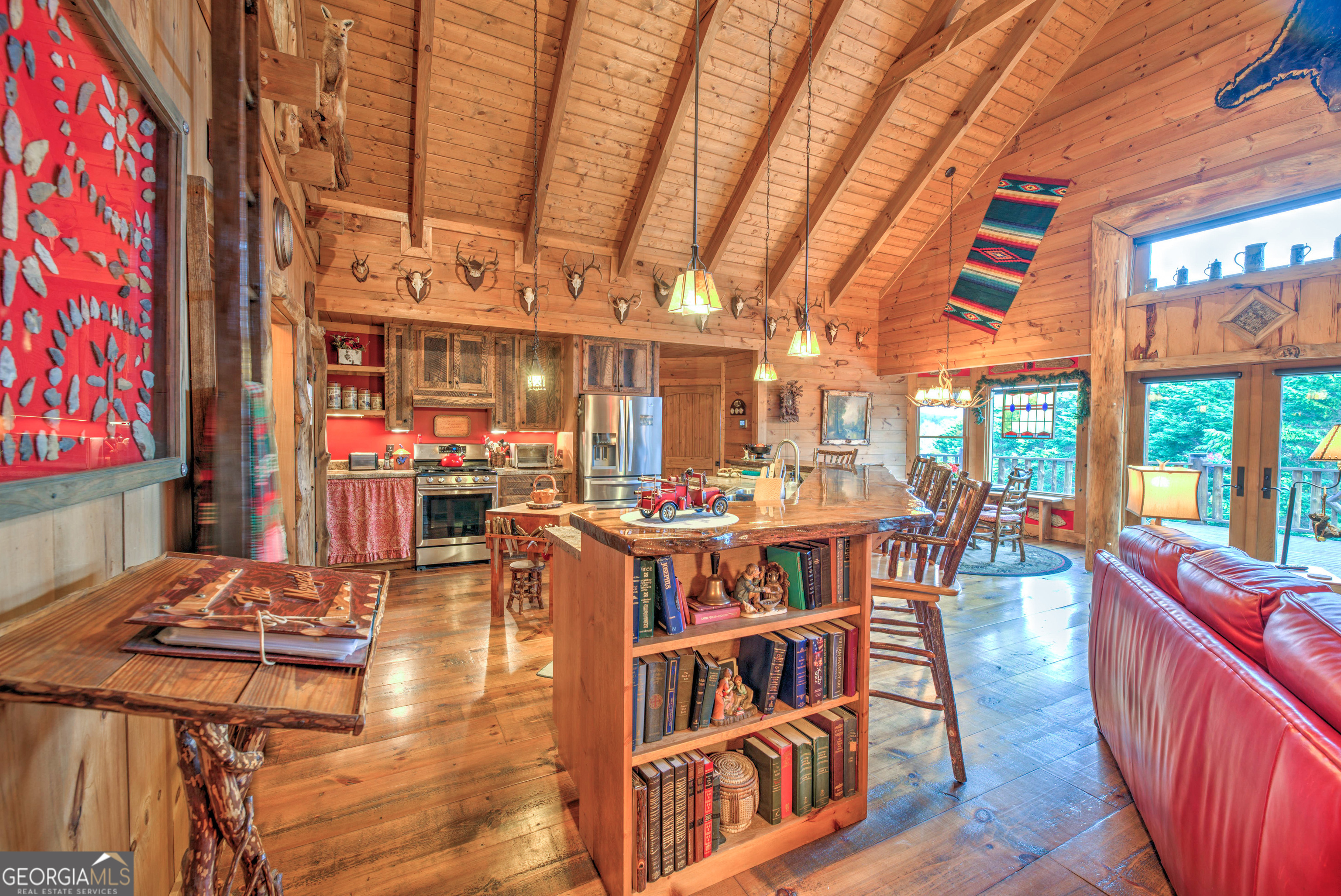 5232 Crow Creek Road Lakemont, GA 30552 - Photo 21 of 90 a living room with furniture a rug and a chandelier