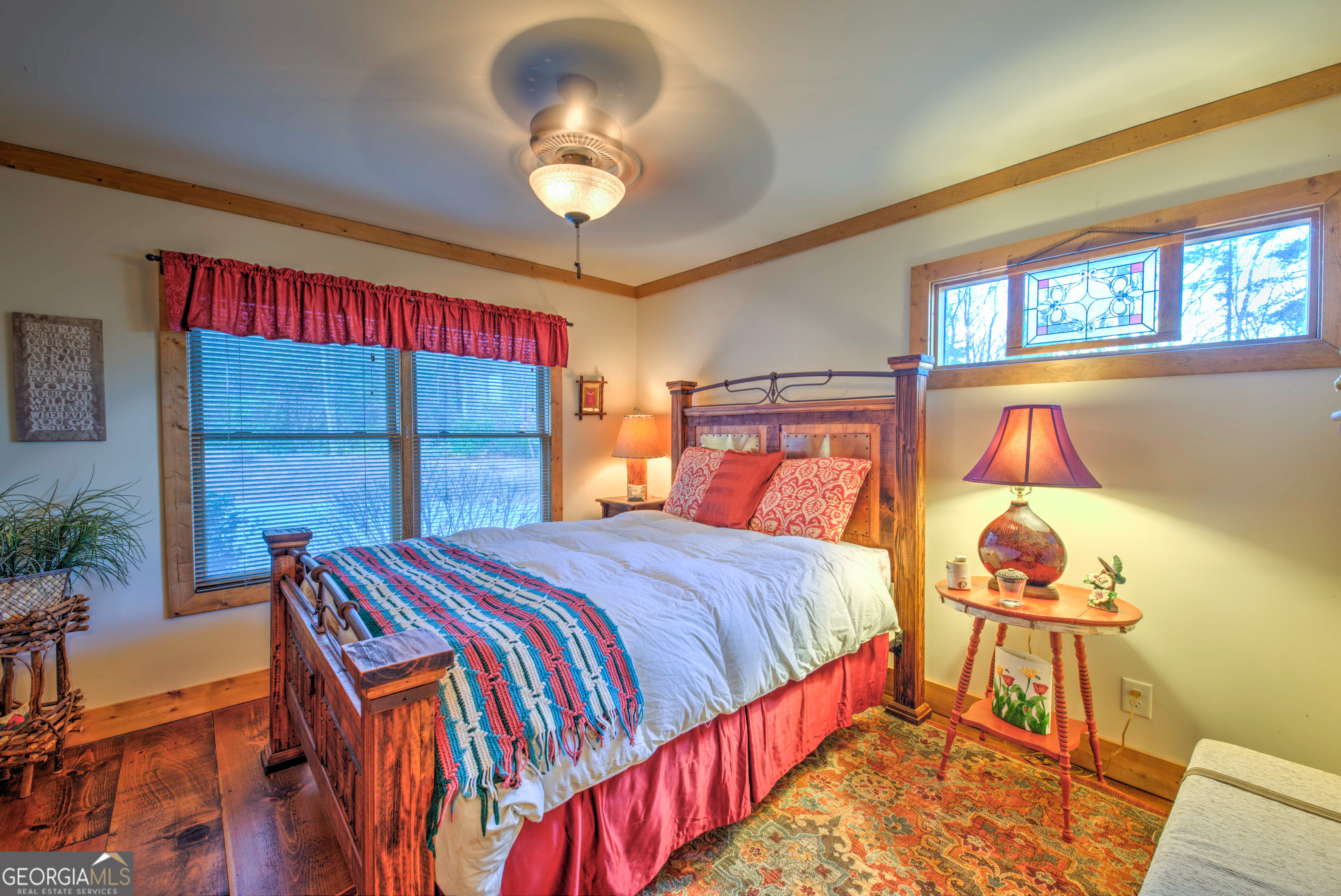 5232 Crow Creek Road Lakemont, GA 30552 - Photo 61 of 90 a bedroom with a bed and a chandelier