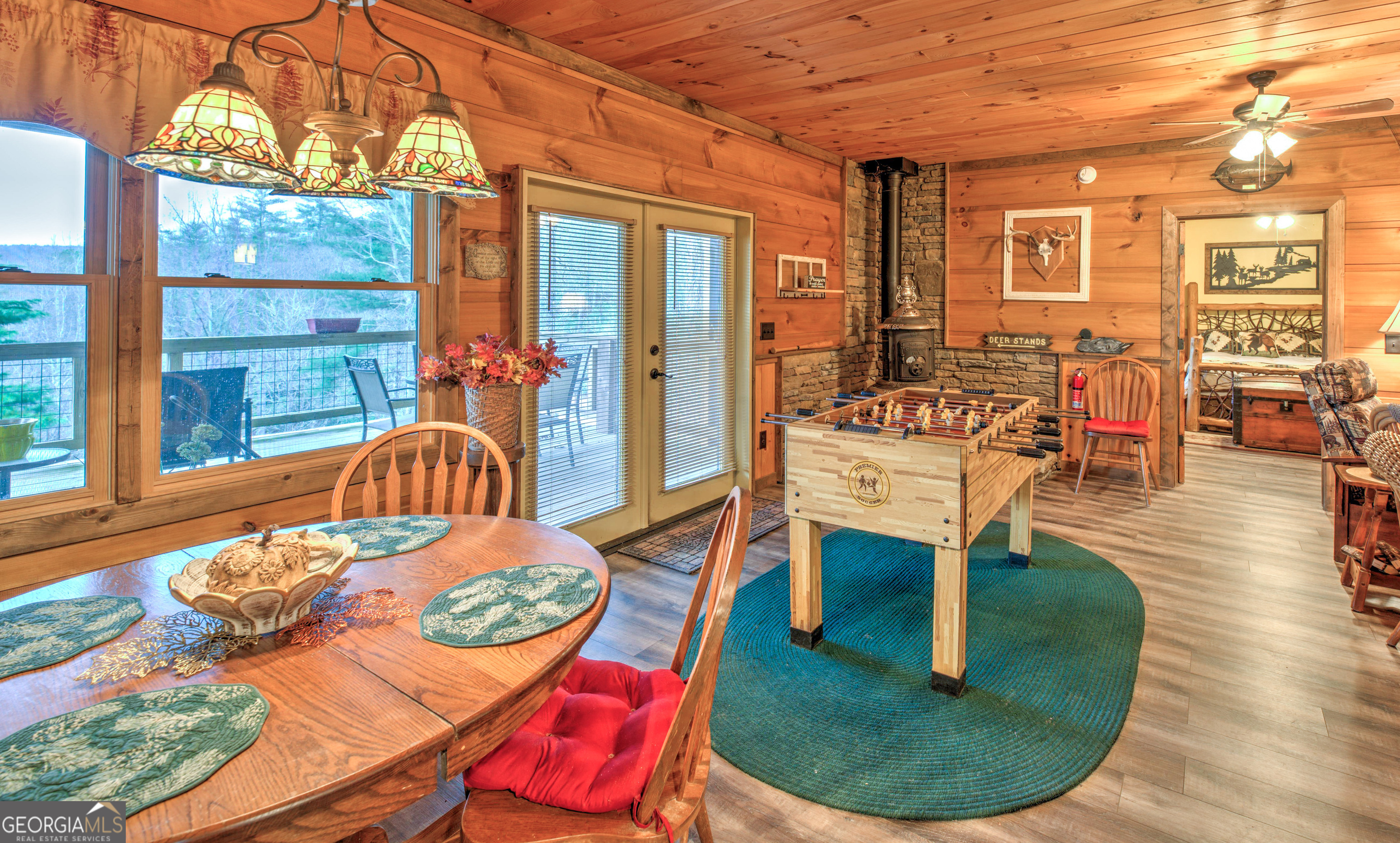 5232 Crow Creek Road Lakemont, GA 30552 - Photo 63 of 90 a dining room with furniture a rug and wooden floor