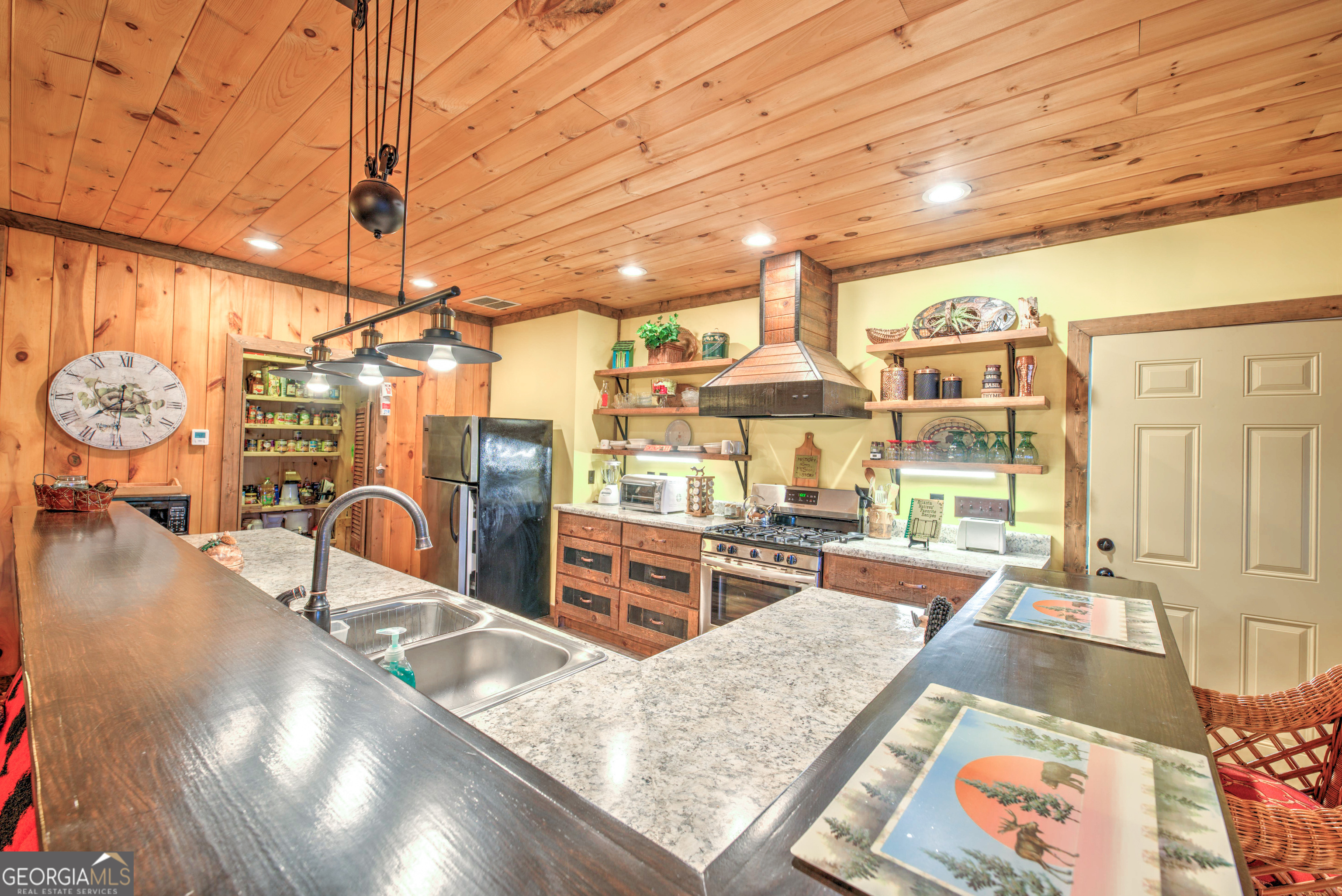 5232 Crow Creek Road Lakemont, GA 30552 - Photo 66 of 90 a dining hall with stainless steel appliances granite countertop a sink and wooden cabinets