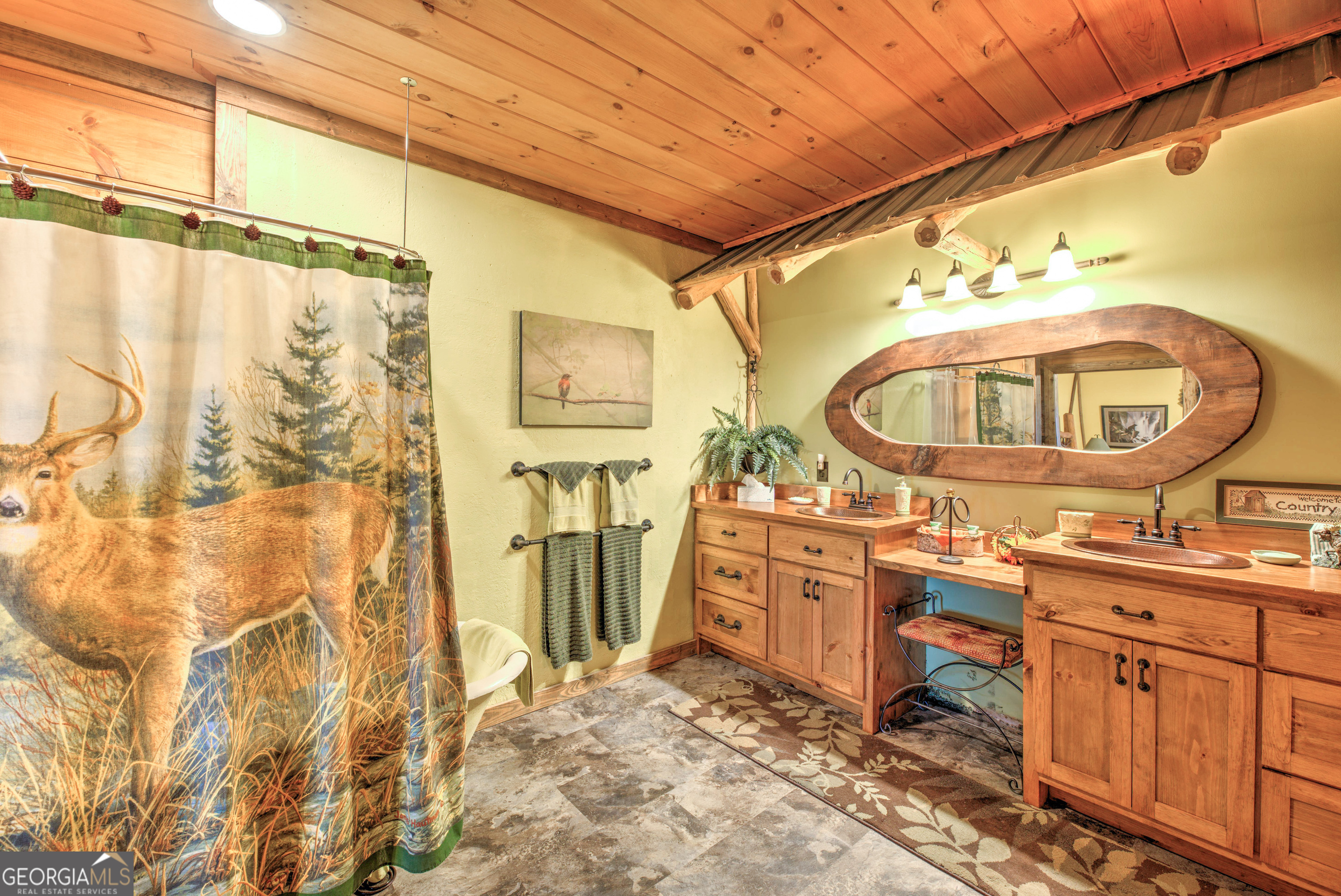 5232 Crow Creek Road Lakemont, GA 30552 - Photo 69 of 90 a view of a bathroom with a sink a mirror and a shower curtain