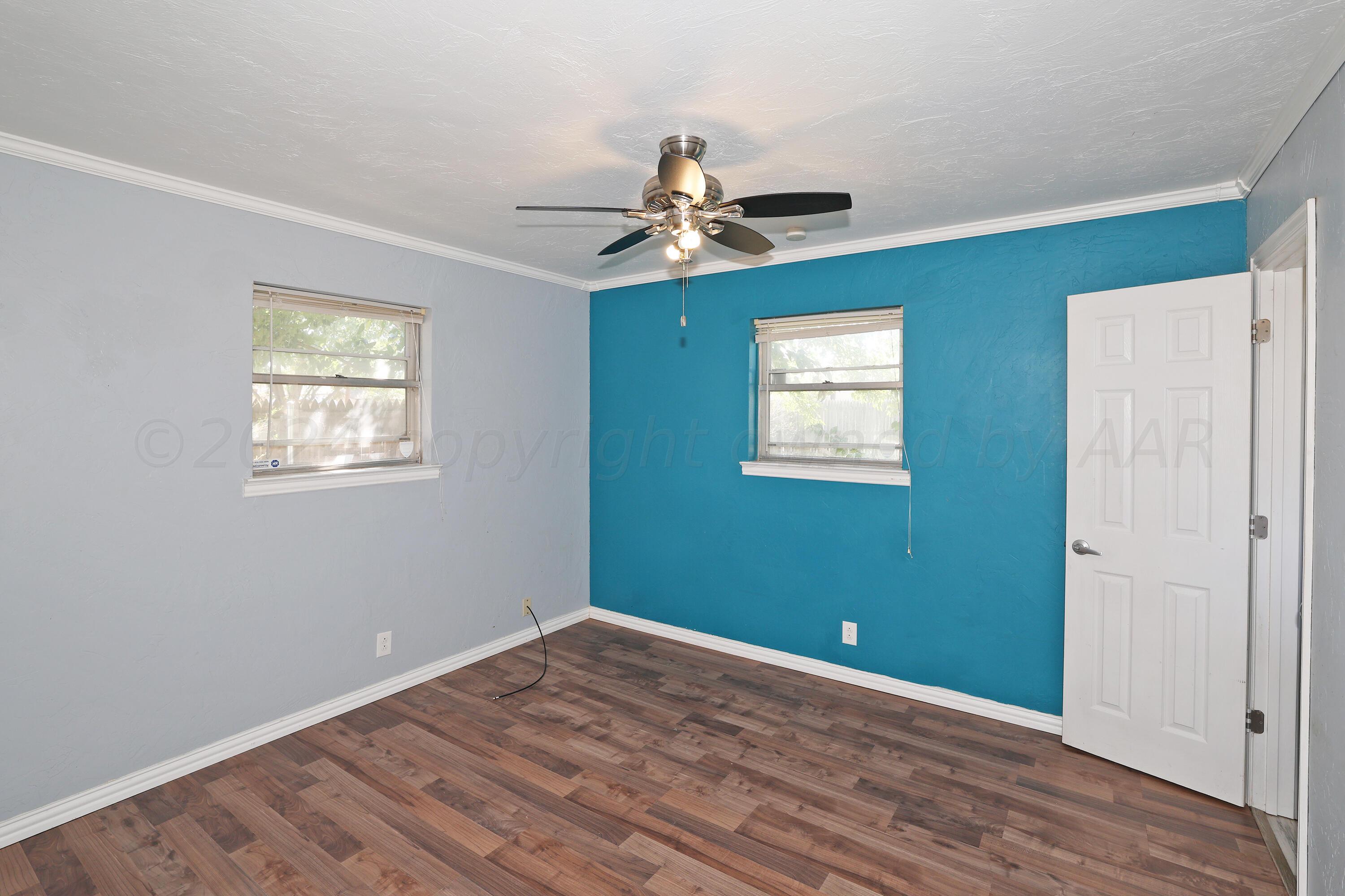 5206 South Travis Street Amarillo, TX 79110 - Photo 11 of 21 wooden floor in an empty room with a window