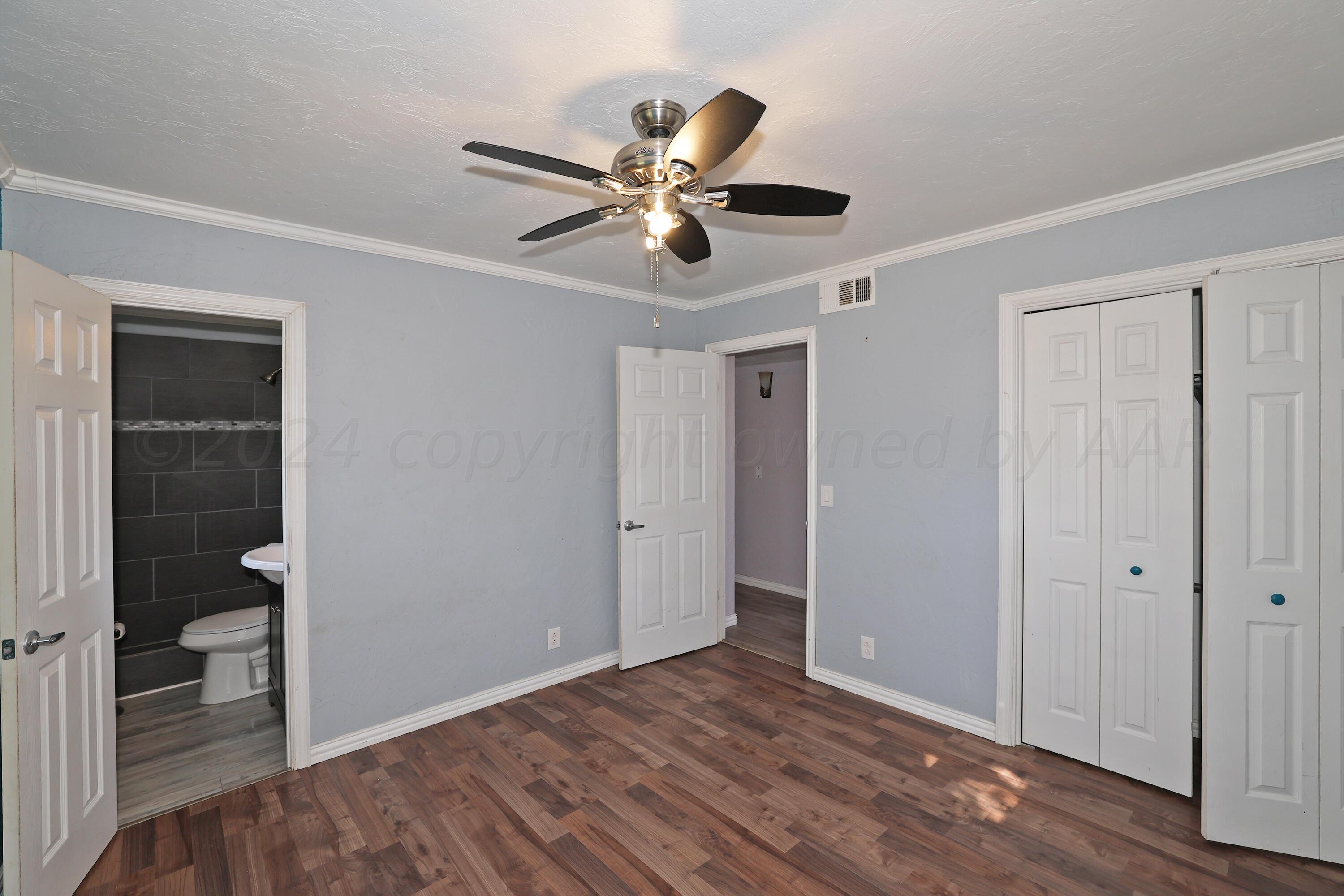 5206 South Travis Street Amarillo, TX 79110 - Photo 12 of 21 a view of empty room with wooden floor