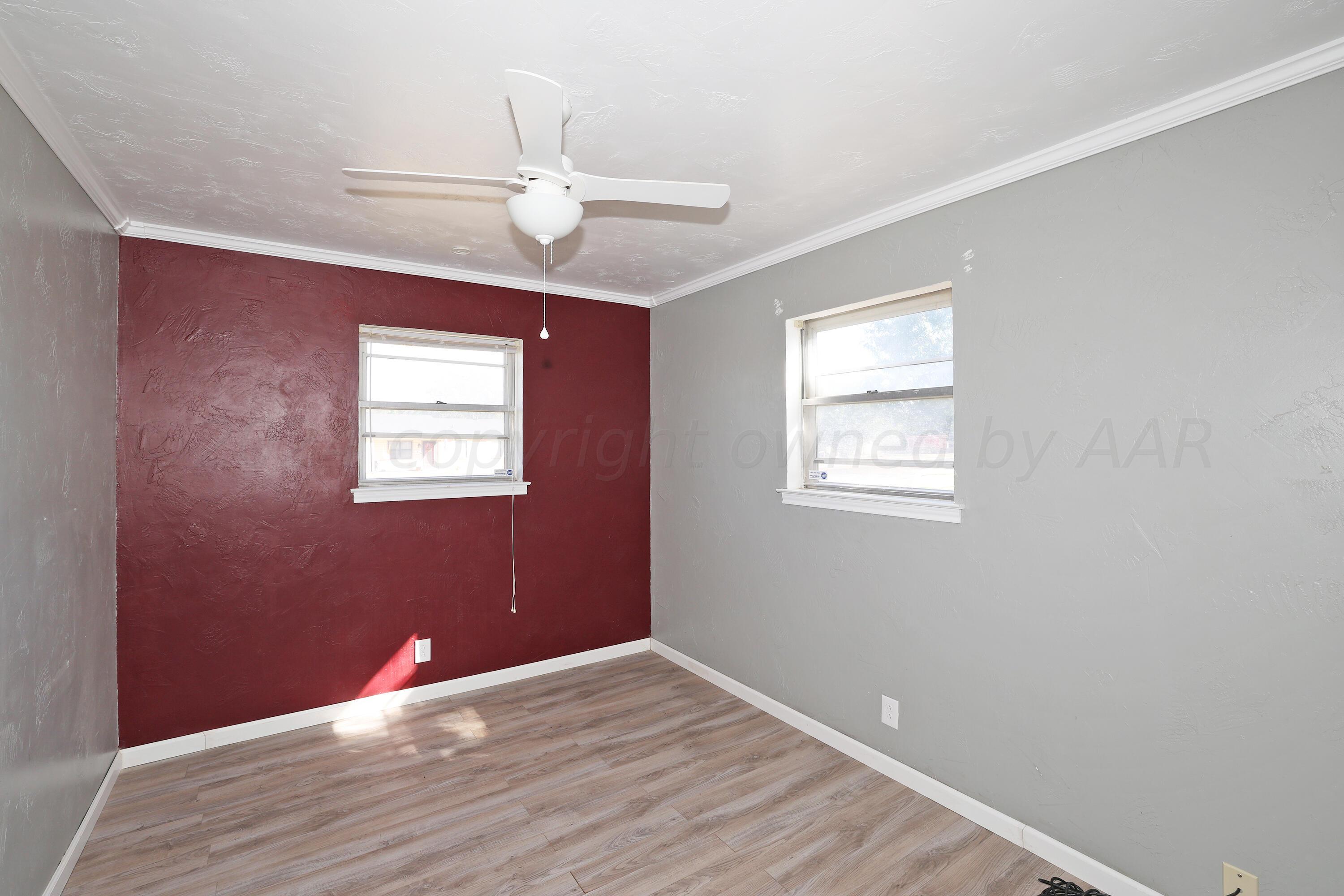 5206 South Travis Street Amarillo, TX 79110 - Photo 14 of 21 a view of an empty room with wooden floor