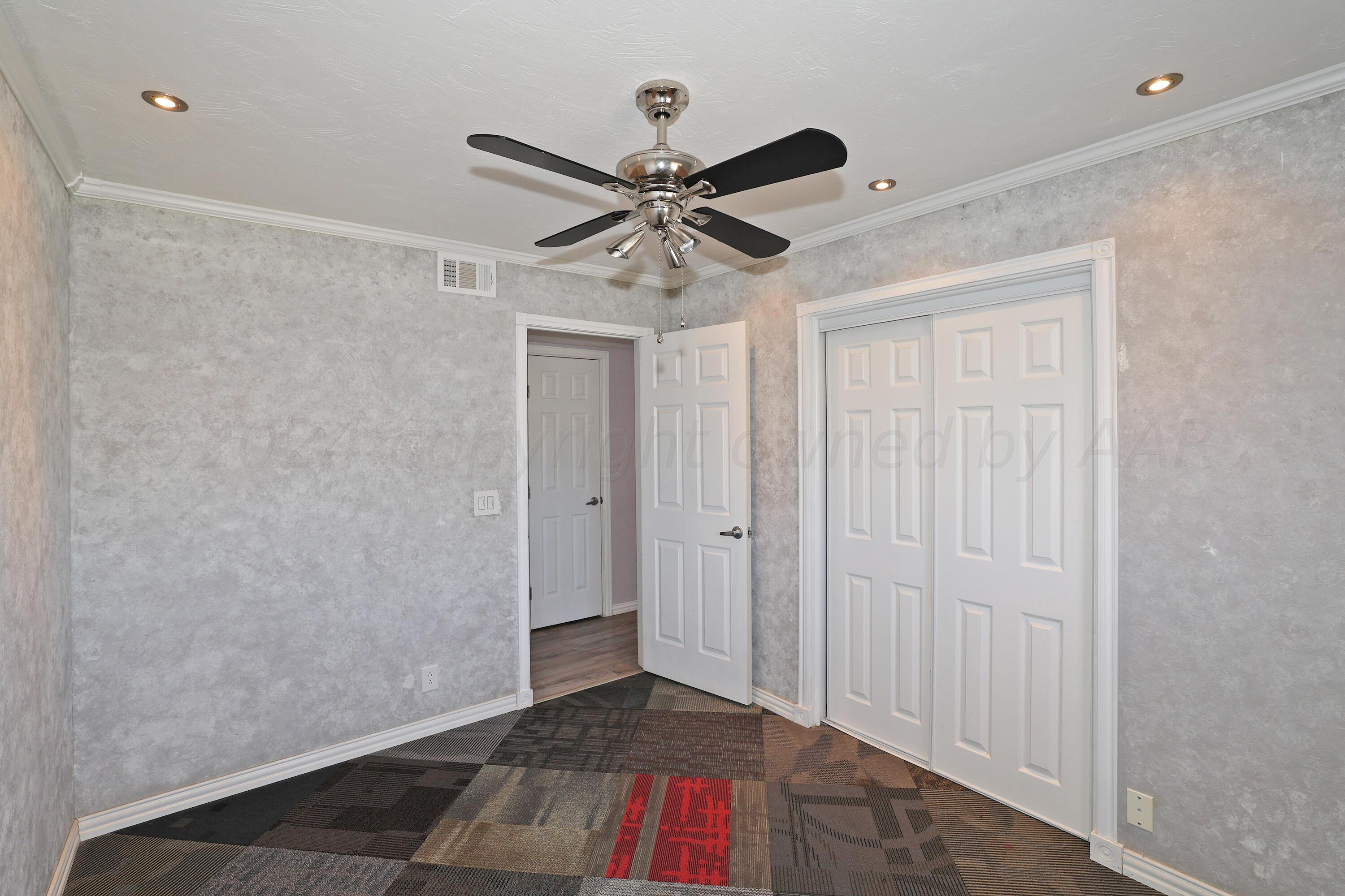 5206 South Travis Street Amarillo, TX 79110 - Photo 17 of 21 a view of entryway with a ceiling fan and wooden floor