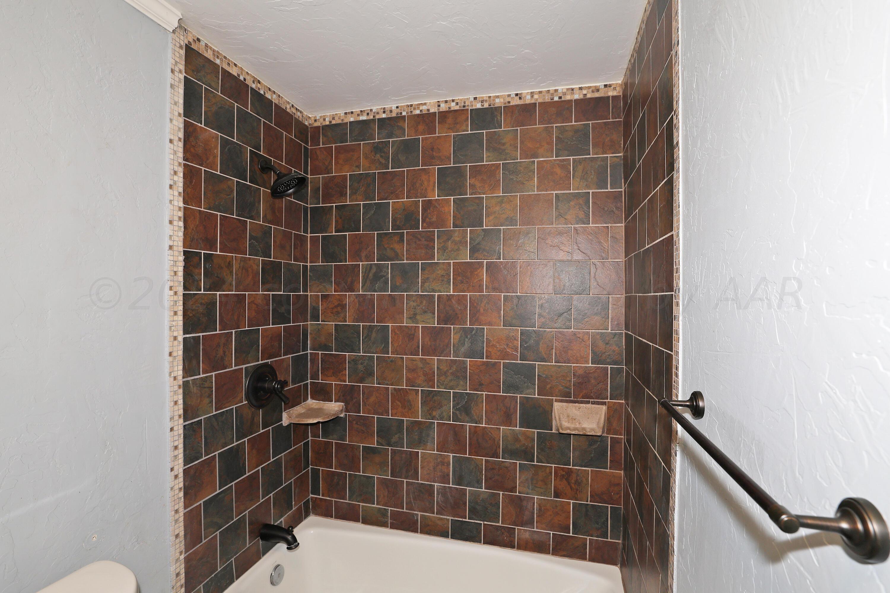 5206 South Travis Street Amarillo, TX 79110 - Photo 19 of 21 a bathroom with a shower
