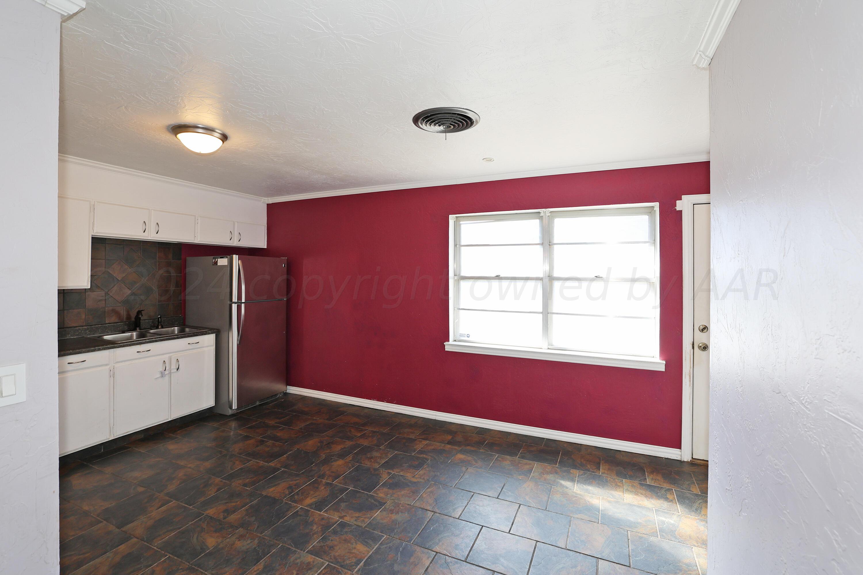 5206 South Travis Street Amarillo, TX 79110 - Photo 8 of 21 a view of an empty room with a window