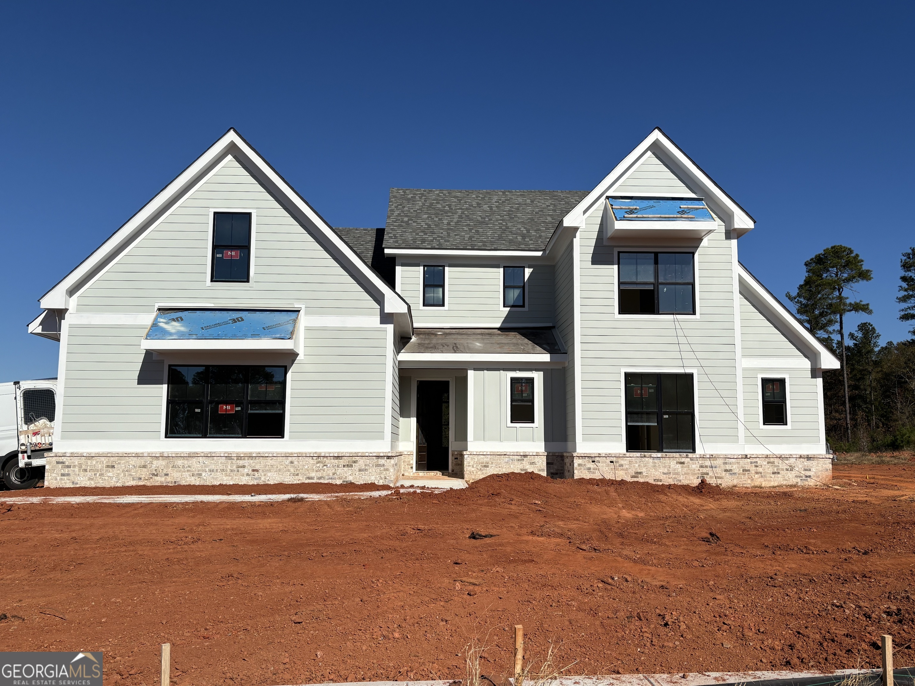 a view of a house with wooden stairs and a yard