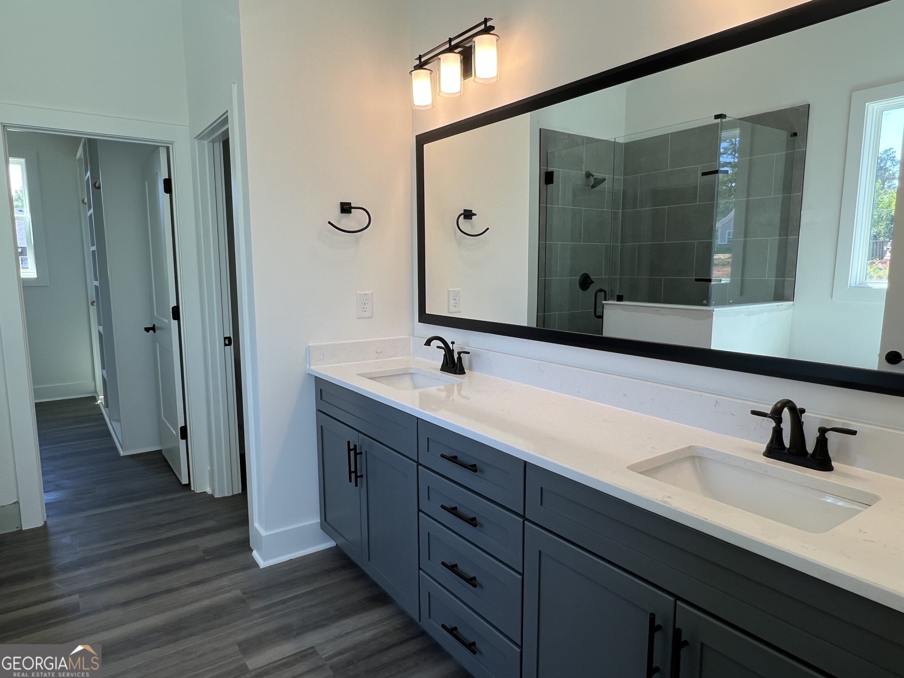 155 Hawthorne Lane Forsyth, GA 31029 - Photo 24 of 46 a spacious bathroom with double sink and a mirror