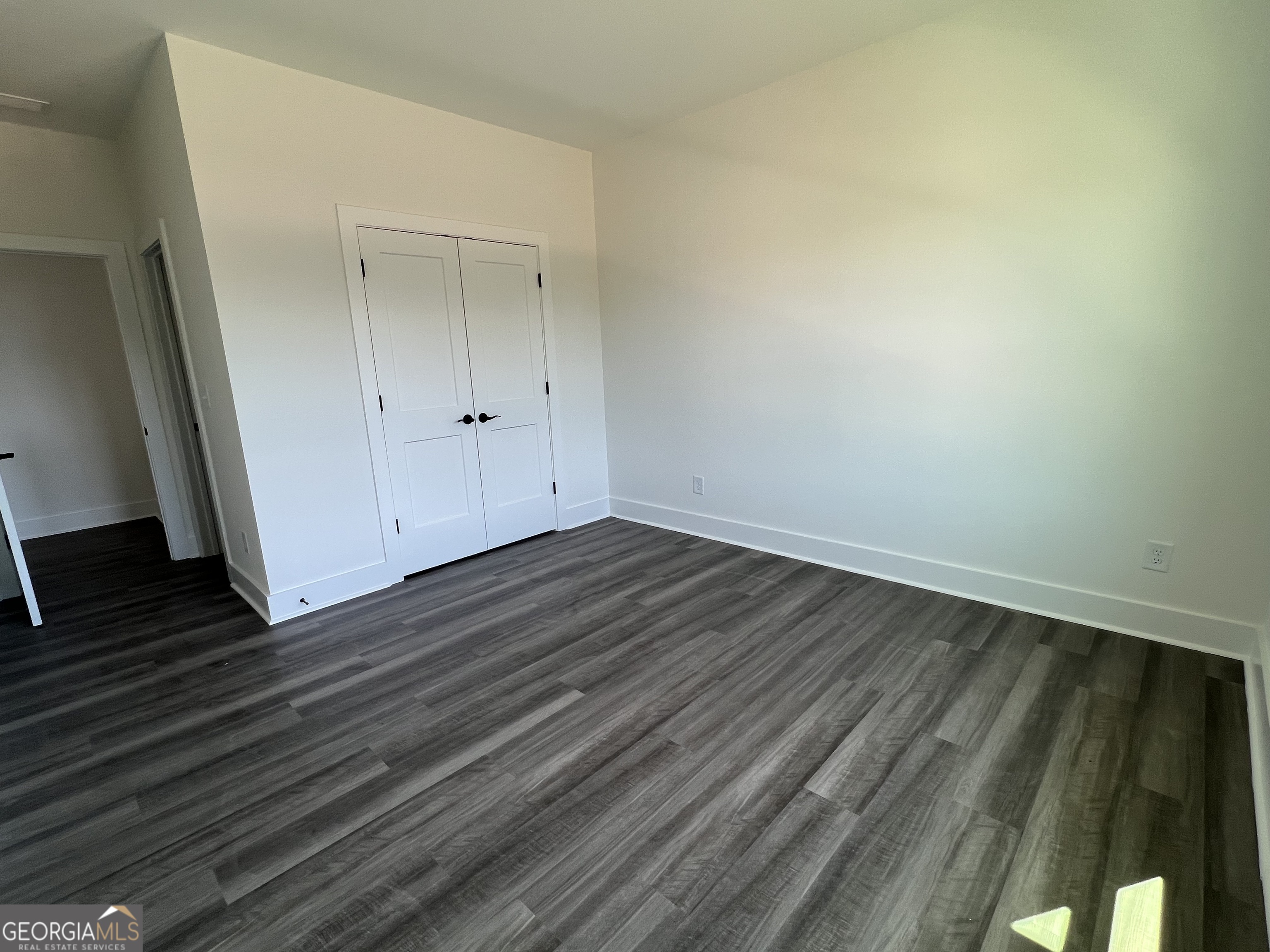 155 Hawthorne Lane Forsyth, GA 31029 - Photo 34 of 46 a view of wooden floor in an empty room