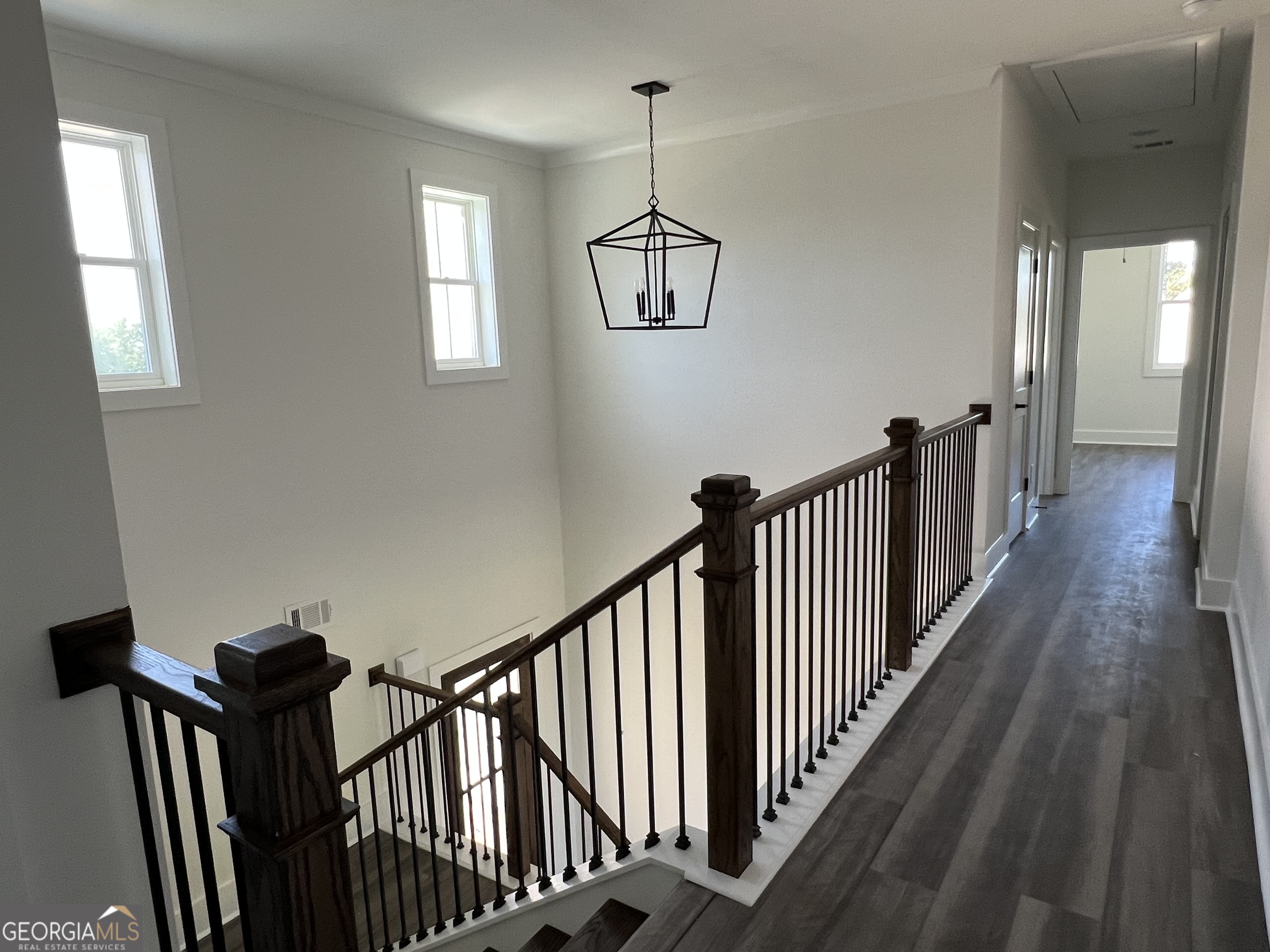 155 Hawthorne Lane Forsyth, GA 31029 - Photo 42 of 46 a view of a hallway with wooden floor and staircase