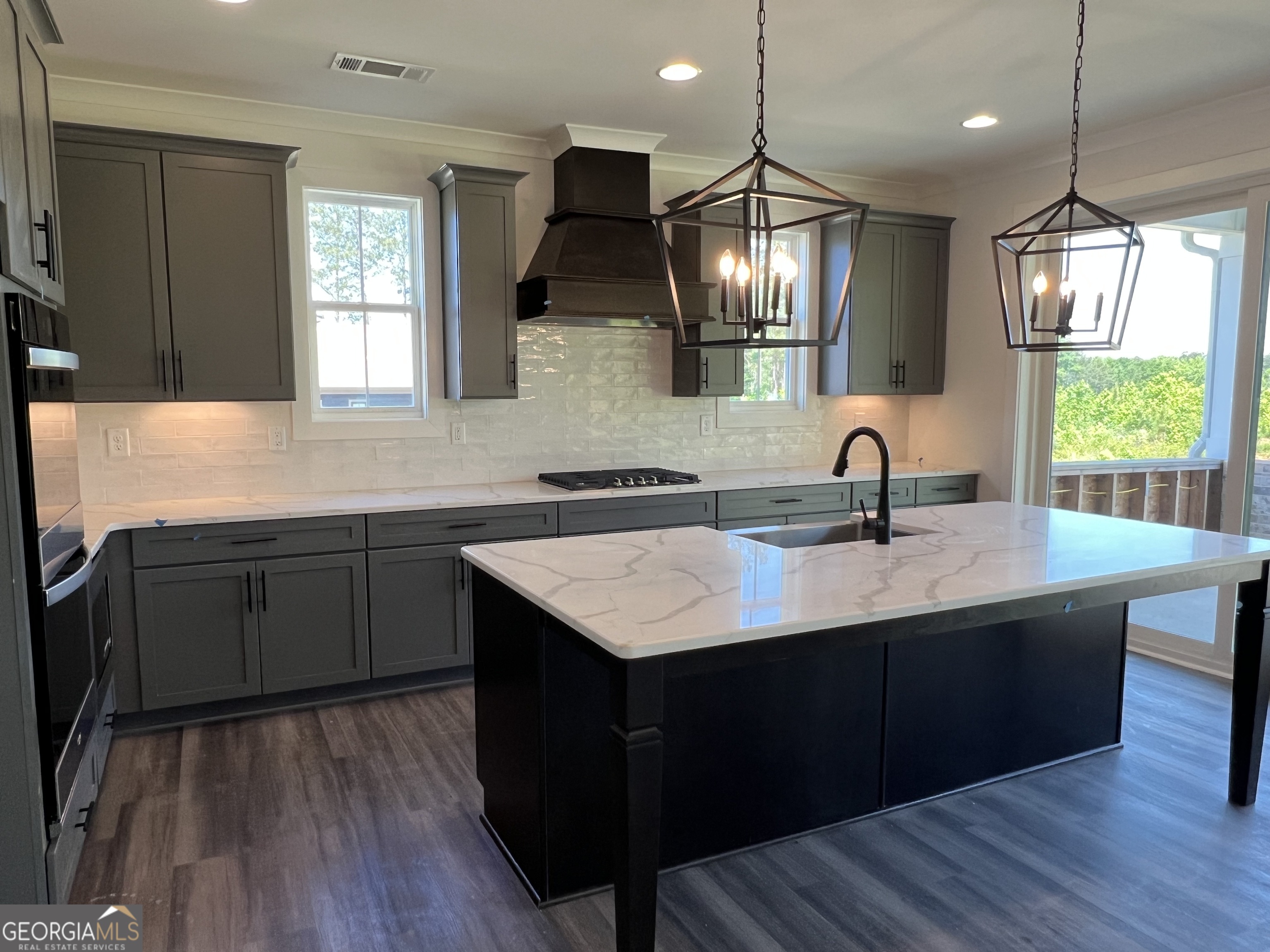 155 Hawthorne Lane Forsyth, GA 31029 - Photo 8 of 46 a kitchen with a sink a counter space appliances and a window