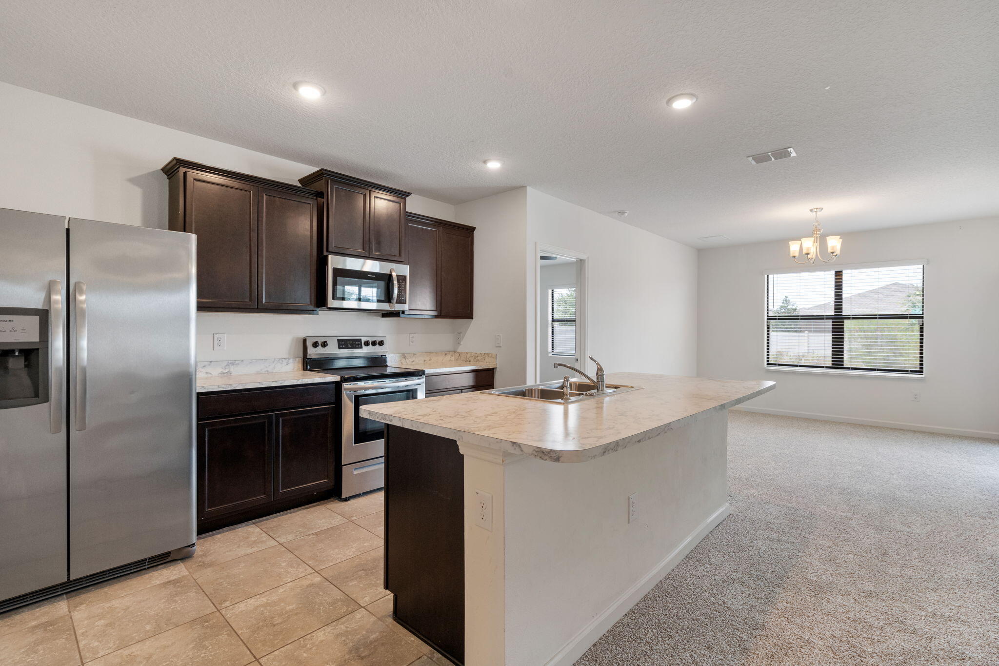376 Snook Place Cocoa, FL 32927 - Photo 2 of 26 a large kitchen with cabinets stainless steel appliances and a window