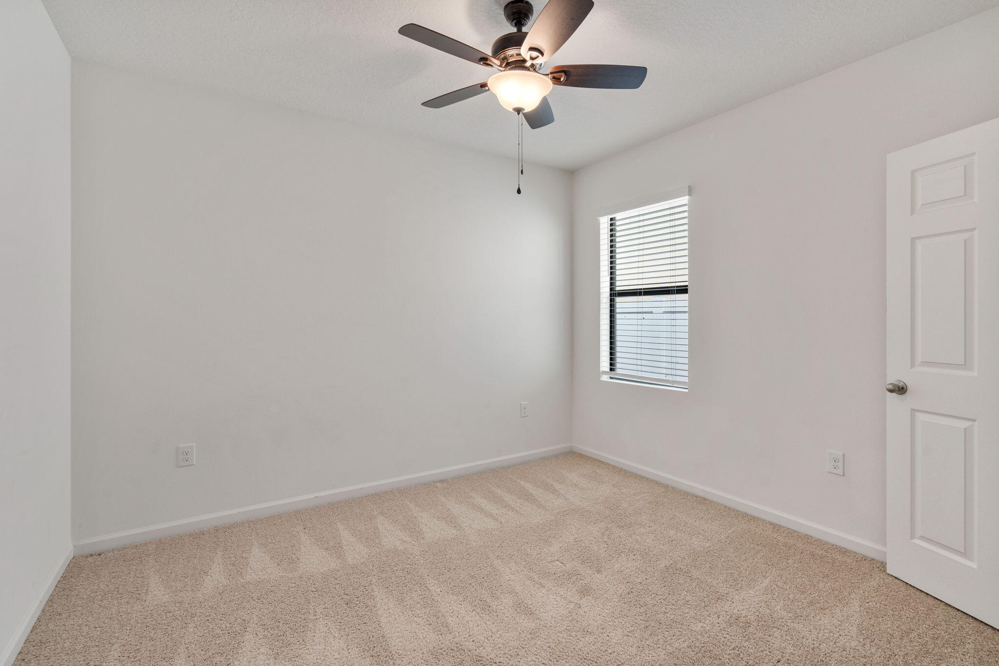 376 Snook Place Cocoa, FL 32927 - Photo 21 of 26 an empty room with a window and a fan