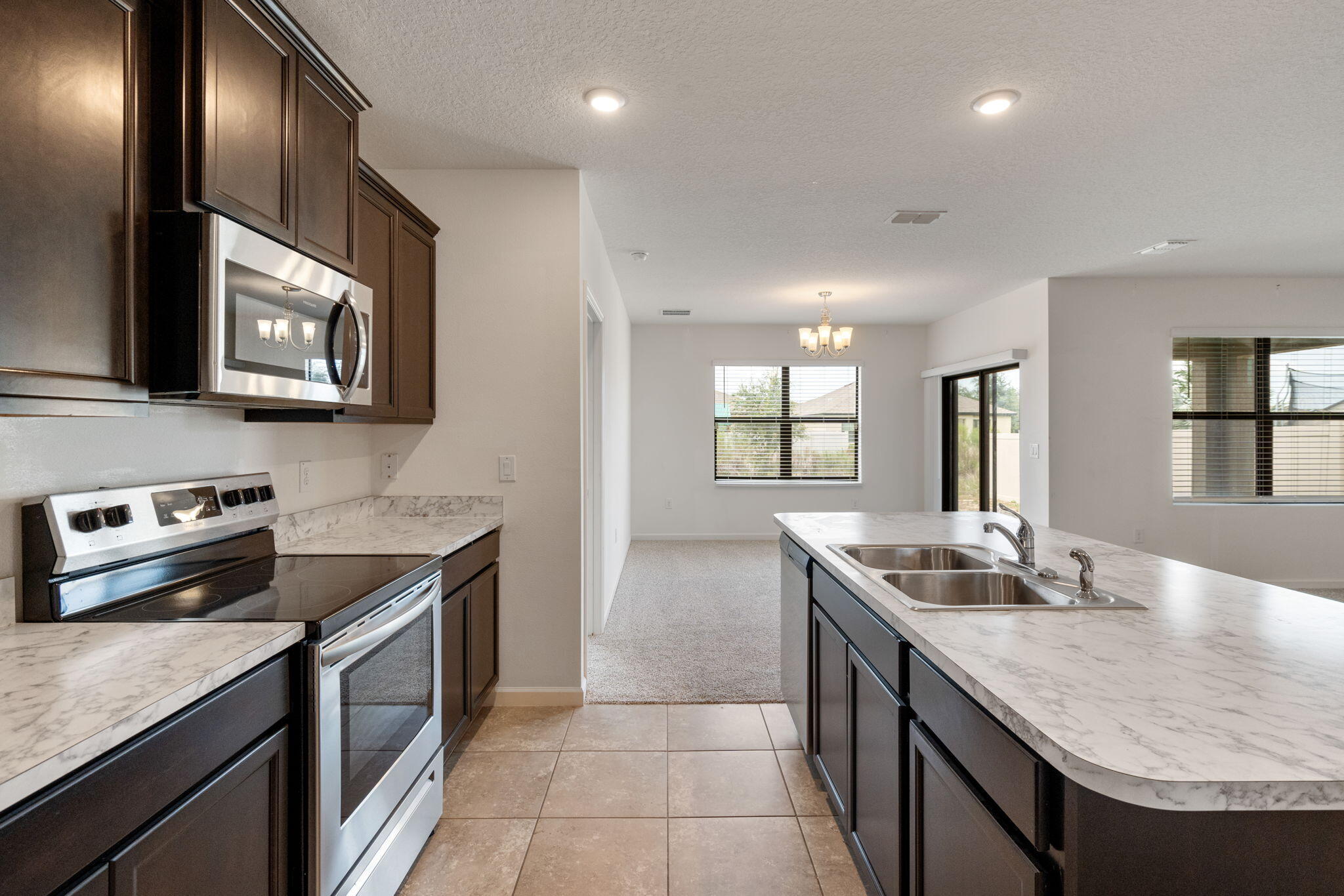 376 Snook Place Cocoa, FL 32927 - Photo 4 of 26 a kitchen with stainless steel appliances granite countertop a sink stove and cabinets