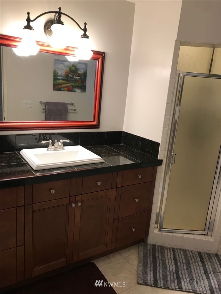 7611 Northeast 12th Street Medina, WA 98039 - Photo 16 of 23 a bathroom with a sink and a mirror