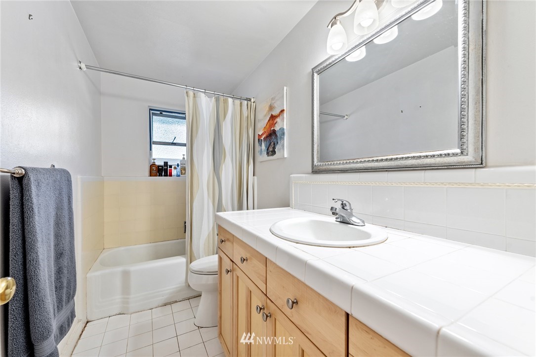 7611 Northeast 12th Street Medina, WA 98039 - Photo 17 of 23 a bathroom with a sink a toilet a shower and a mirror