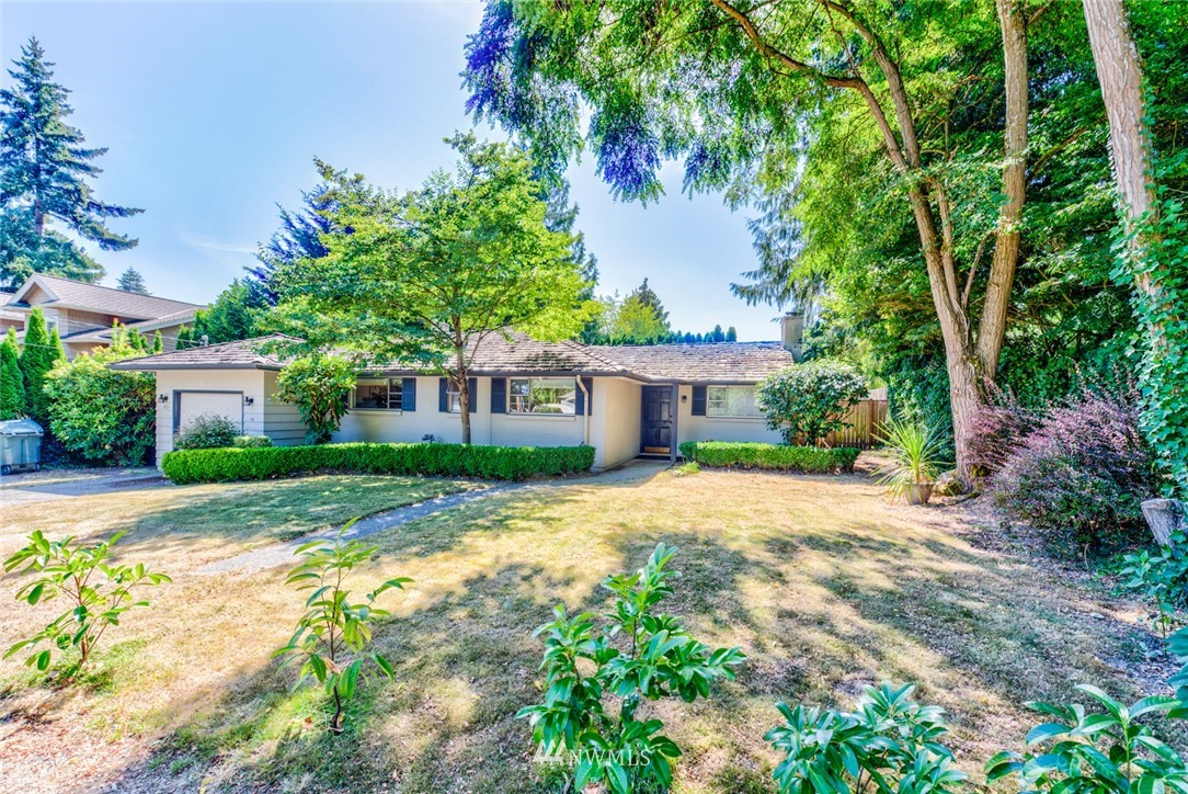 7611 Northeast 12th Street Medina, WA 98039 - Photo 21 of 23 a front view of a house with a garden and trees