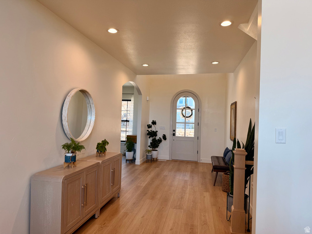 3626 Riverstone Road Mapleton, UT 84664 - Photo 7 of 58 Entrance foyer featuring arched walkways, light wood-style floors, and recessed lighting