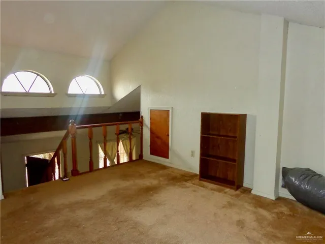 a view of an empty room with a fireplace