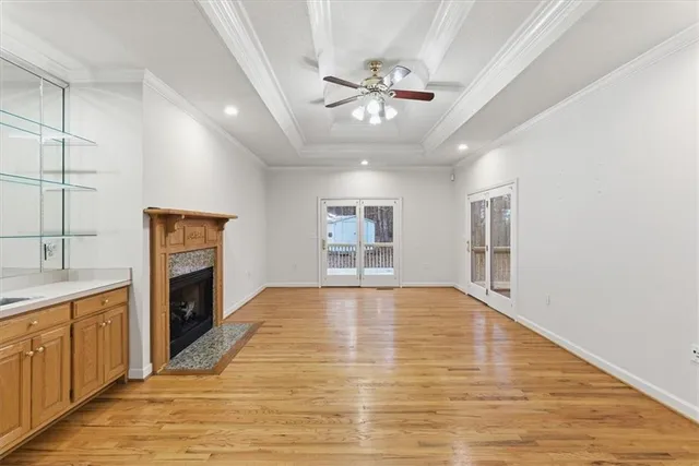 a view of an empty room with a fireplace and a window