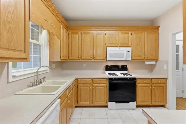 a view of a kitchen with a stove cabinets