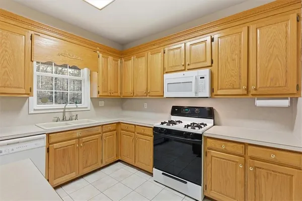 a view of a room with wooden floor and a ceiling fan