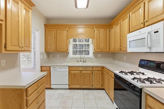 a kitchen with stainless steel appliances granite countertop a stove sink and cabinets