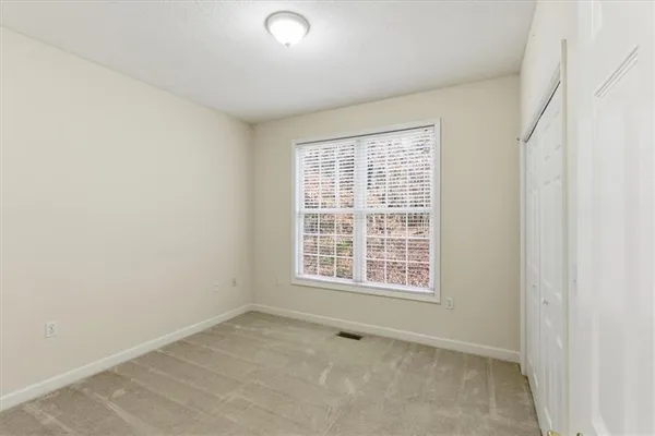 a view of empty room with wooden walls