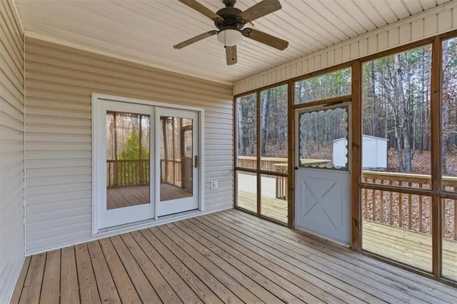 a view of balcony with wooden floor and fence