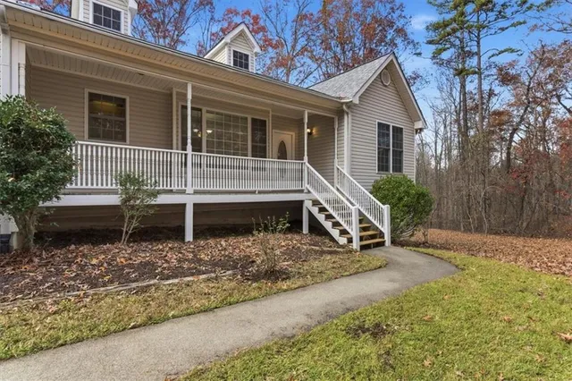 a front view of a house with garden and porch