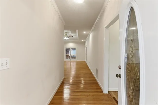 a view of a hallway with wooden floor