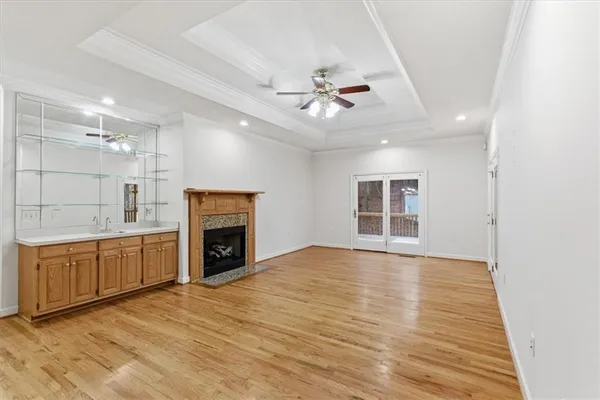 a view of an empty room with a fireplace and a window
