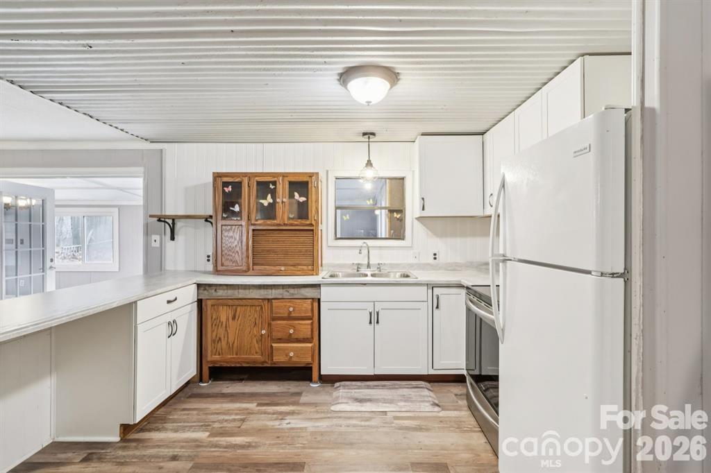 920 Dewitt Helms Road Monroe, NC 28112 - Photo 13 of 47 a kitchen with white cabinets and white appliances