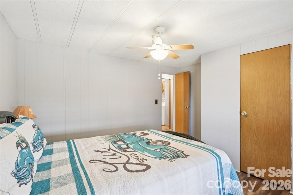 920 Dewitt Helms Road Monroe, NC 28112 - Photo 21 of 47 a bedroom that has a bed and a chandelier