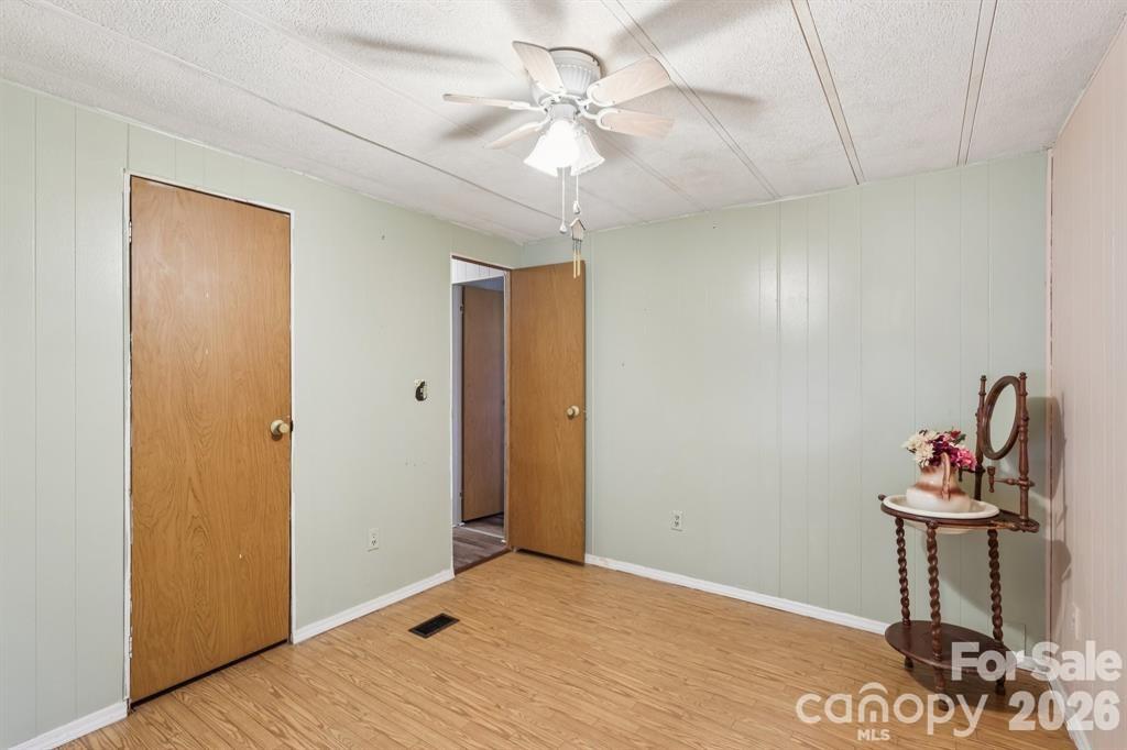 920 Dewitt Helms Road Monroe, NC 28112 - Photo 23 of 47 a view of a room with a chandelier fan and wooden floor