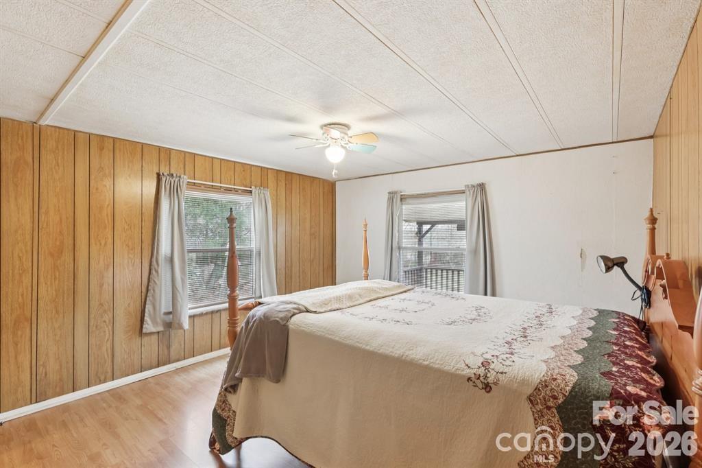 920 Dewitt Helms Road Monroe, NC 28112 - Photo 29 of 47 a bedroom with a large bed and a chandelier